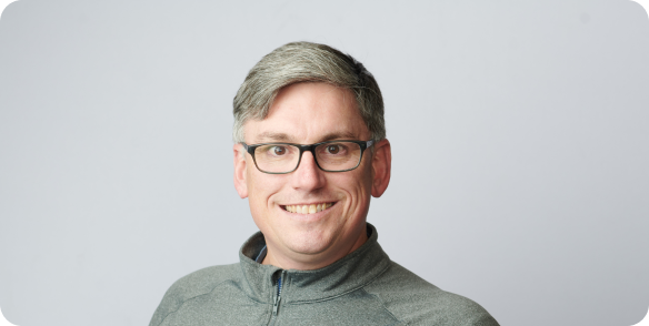 Portrait of Brian Brown smiling in a jacket